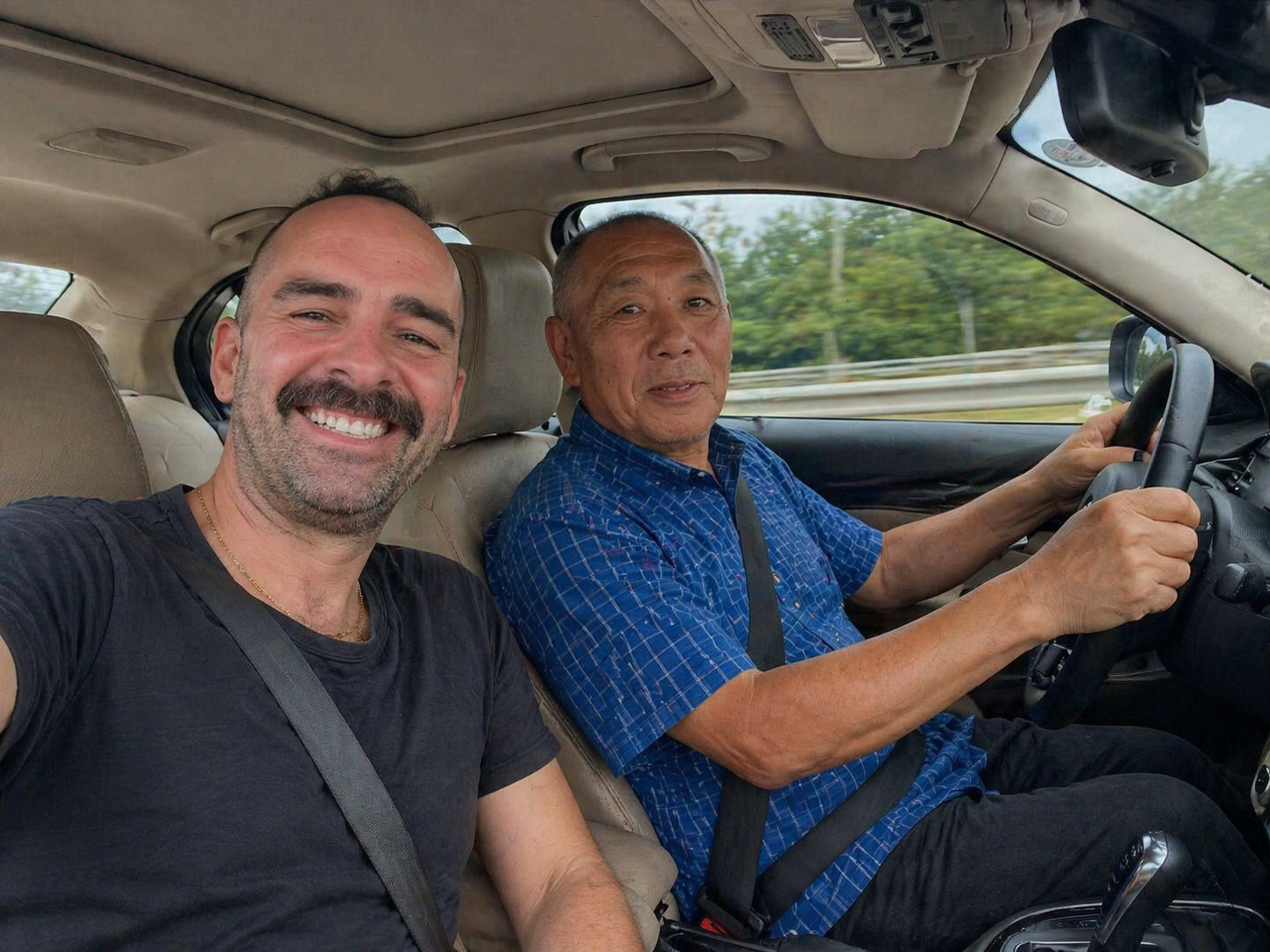 Traveler with a local driver during a road transfer